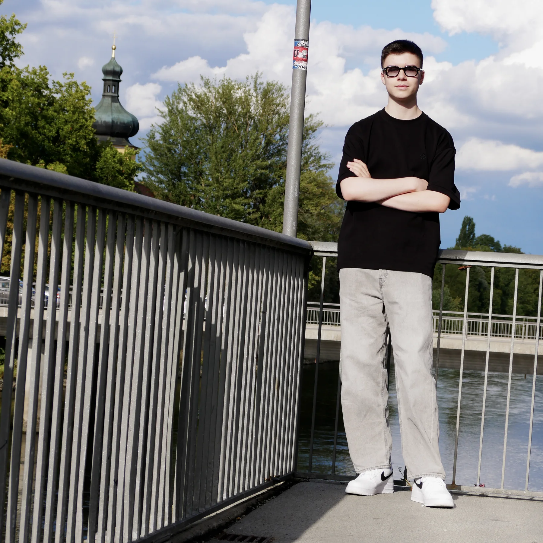 Tobi wearing sunglasses beside a railing for L4TE.